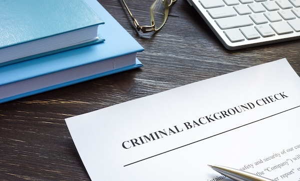 Criminal background check request form with pen.